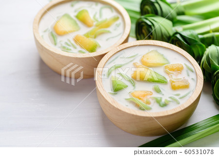 Thai dessert (Lod Chong), rice flour pandan flavor and sliced melon fruit in coconut milk 60531078