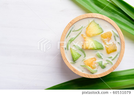 Thai dessert (Lod Chong), rice flour pandan flavor and sliced melon fruit in coconut milk Thai dessert (Lod Chong), rice flour pandan flavor and sliced melon fruit in coconut milk 60531079