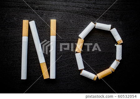 Stop smoking concept on background with broken cigarettes. Heap of cigarettes. No smoking Stop smoking concept on background with broken cigarettes. Heap of cigarettes. No smoking 60532054