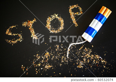 Stop smoking concept on background with broken cigarettes. Heap of cigarettes. No smoking Stop smoking concept on background with broken cigarettes. Heap of cigarettes. No smoking 60532074