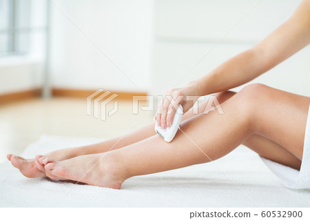 Skin care. Woman shaving her legs in bathroom 60532900