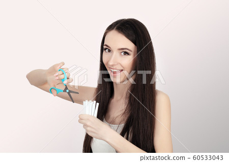 Stop smoking. Quit smoking Women's hands holding a bunch of cigarettes and cut them in half scissors. Stop smoking The concept of health. On a gray background. Stop smoking. Quit smoking Women's hands holding a bunch of cigarettes and cut them in half scissors. Stop smoking The concept of health. On a gray background. 60533043