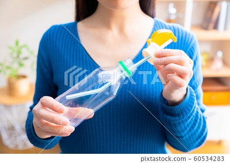 Women who attach plastic bottle straw caps 60534283