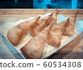 Sweet bread loaf topped with condensed milk 60534308