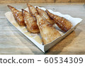 Sweet bread loaf topped with condensed milk 60534309