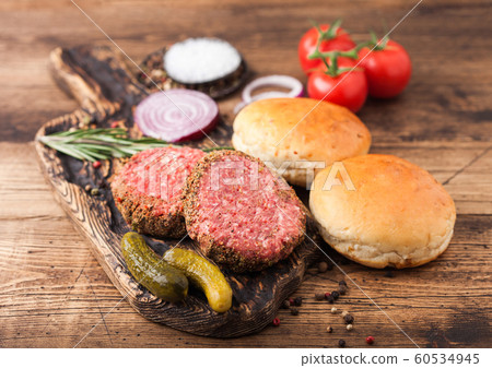 Fresh raw minced pepper beef burgers on vintage Fresh raw minced pepper beef burgers on vintage 60534945