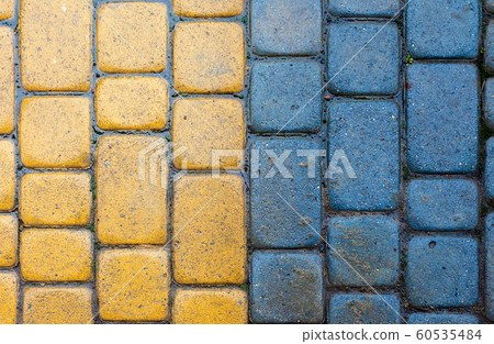 yellow and blue cobbles of pavement texture 60535484