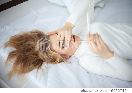 Positive pregnancy test. Young woman feeling depressed and sad after looking at pregnancy test result at home 60537424