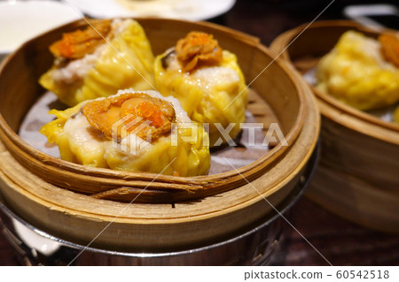 Chinese Dim Sum, Pork Meat Dumplings (Siu Mai) With Abalone in a bamboo basket Chinese Dim Sum, Pork Meat Dumplings (Siu Mai) With Abalone in a bamboo basket 60542518