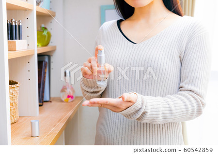 A woman using a spray 60542859