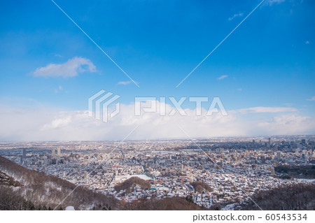 Top view of snow capped city and blue sky Top view of snow capped city and blue sky 60543534