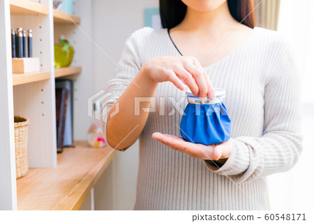 Woman making ice sac Woman making ice sac 60548171