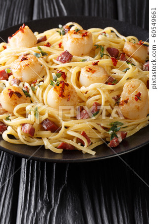 Tasty spaghetti with scallops and bacon in a Tasty spaghetti with scallops and bacon in a 60549661