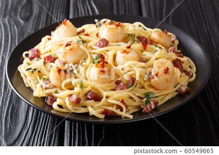 Spicy spaghetti served with scallops and bacon in Spicy spaghetti served with scallops and bacon in 60549665