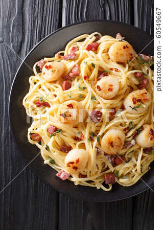 Tasty spaghetti with scallops and bacon in a Tasty spaghetti with scallops and bacon in a 60549667