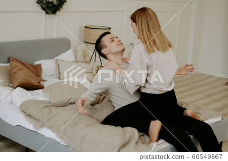 Business couple on bed in hotel room Business couple on bed in hotel room 60549867