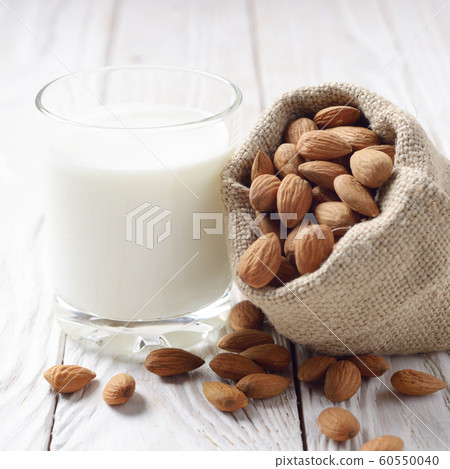 Milk or yogurt in drinking glass on white wooden 60550040