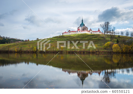 The pilgrimag church on Zelena Hora - Green Hill - Monument UNESCO. St. Jan Nepomucky Church panorama in autumn scene with reflection in the lake water. The pilgrimag church on Zelena Hora - Green Hill - Monument UNESCO. St. Jan Nepomucky Church panorama in autumn scene with reflection in the lake water. 60550121