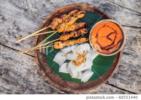 Indonesian chicken satay or Sate Ayam served with lontong, soy sauce and peanut sauce lifestyle food Indonesian chicken satay or Sate Ayam served with lontong, soy sauce and peanut sauce lifestyle food 60551440