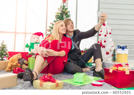 Happiness couple making selfie with colorful decoration accessories Happiness couple making selfie with colorful decoration accessories 60552935