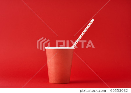 Red paper coffee cup with straw on the red Red paper coffee cup with straw on the red 60553082