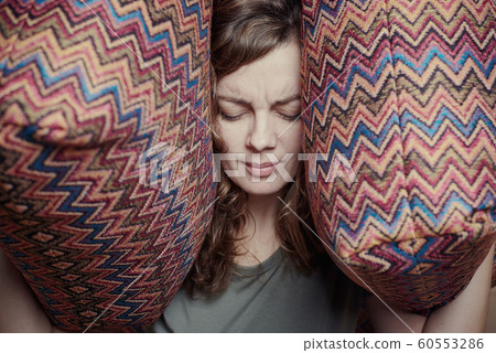 Woman close ears with the pillows. Stressed woman 60553286