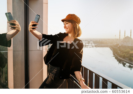 Young and beautiful woman with city and river landscape 60553614