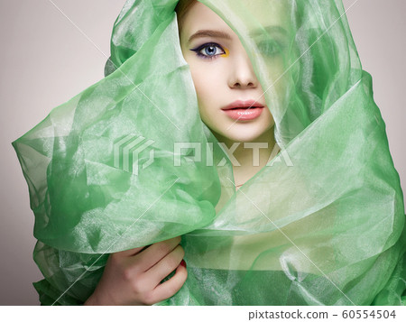 beautiful young woman in green silk veil. colorful 60554504