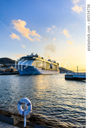 Passenger boat illuminated from the waterside forest park in the setting sun [Nagasaki City] 60554736