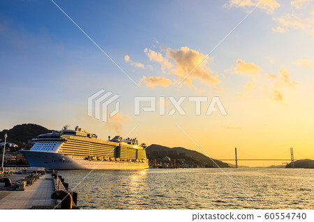 Passenger boat illuminated from the waterside forest park in the setting sun [Nagasaki City] 60554740