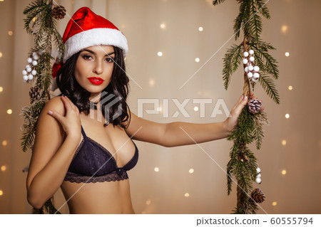 beautiful woman on swing with Christmas decorations 60555794