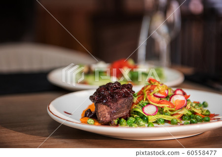 Roasted beef with berries sauce 60558477