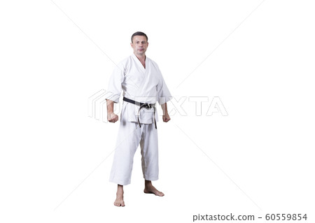 Adult athlete performs formal goju-ryu exercises. 60559854