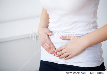Pain stomach. Woman having painful stomachache,Female suffering from abdominal pain 60560082