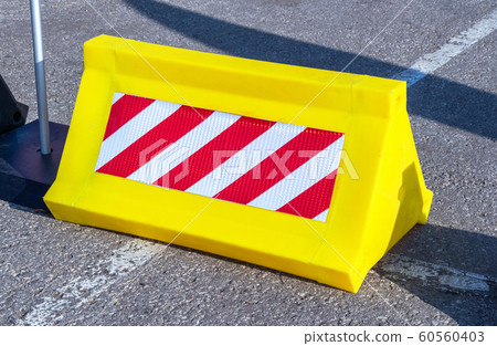 Road barrier with red and white striped caution Road barrier with red and white striped caution 60560403
