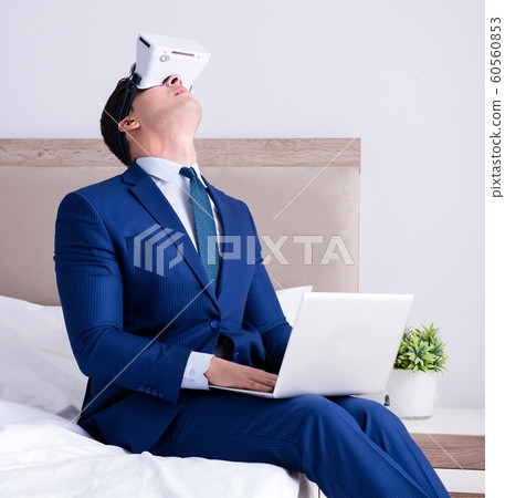 Businessman wearing a virtual reality headset in the bedroom 60560853