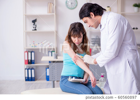 Young arm injured woman visiting young doctor traumatologist Young arm injured woman visiting young doctor traumatologist 60560897