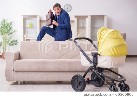 Young businessman looking after baby 60560903