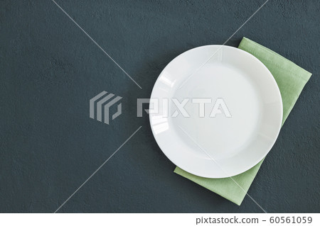 Empty plate on dark stone background. Empty plate on dark stone background. 60561059