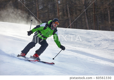 Skiing in the winter snowy slopes 60561330