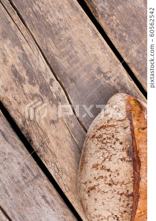 Loaf of homemade bread on rustic wooden background. Loaf of homemade bread on rustic wooden background. 60562542