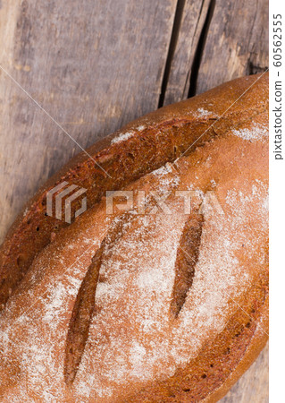Close up of fresh bread on wooden background. 60562555