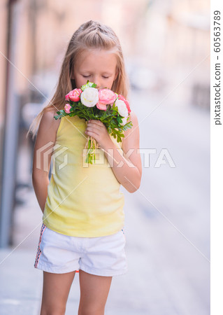 Adorable little girl in european city outdoors Adorable little girl in european city outdoors 60563789