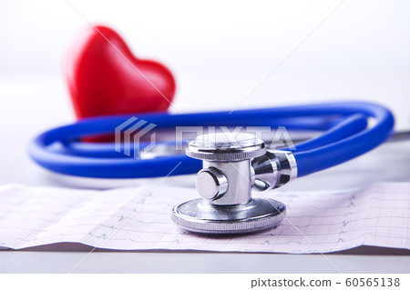 Medical stethoscope and red heart lying on cardiogram chart closeup. Medical help, prophylaxis, disease prevention or insurance concept. Cardiology care. 60565138