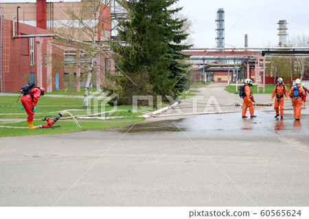 Professional firefighters in orange fire- 60565624