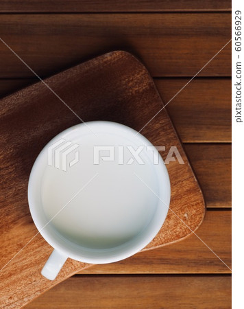 Fresh milk in a white porcelain cup Fresh milk in a white porcelain cup 60566929