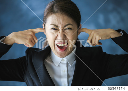 A woman clogging the ear 60568154