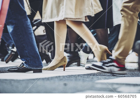 People crossing a pedestrian crossing 60568705