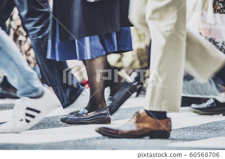 People crossing a pedestrian crossing People crossing a pedestrian crossing 60568706