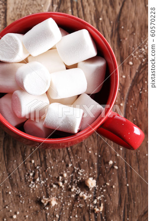 marshmallows in red cup on wooden table marshmallows in red cup on wooden table 60570228